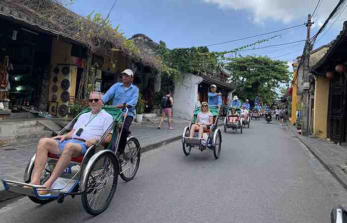 Tourists visit Hoi An by Cyclo